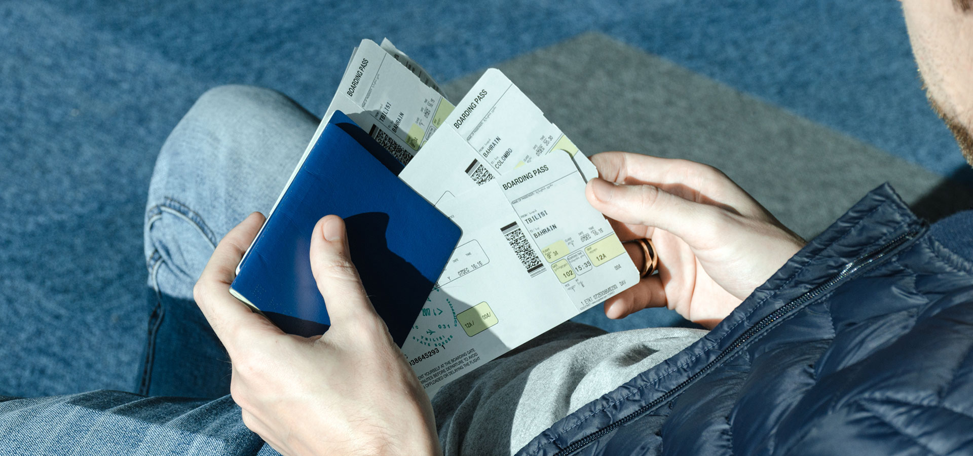 man-with-airplane-tickets-and-passport-4SYCE7N.jpg